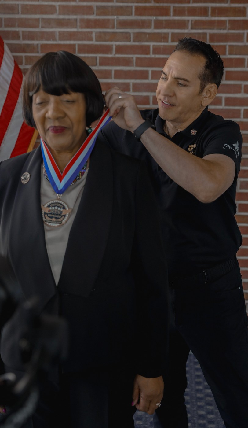 The Community Hero Medal is placed